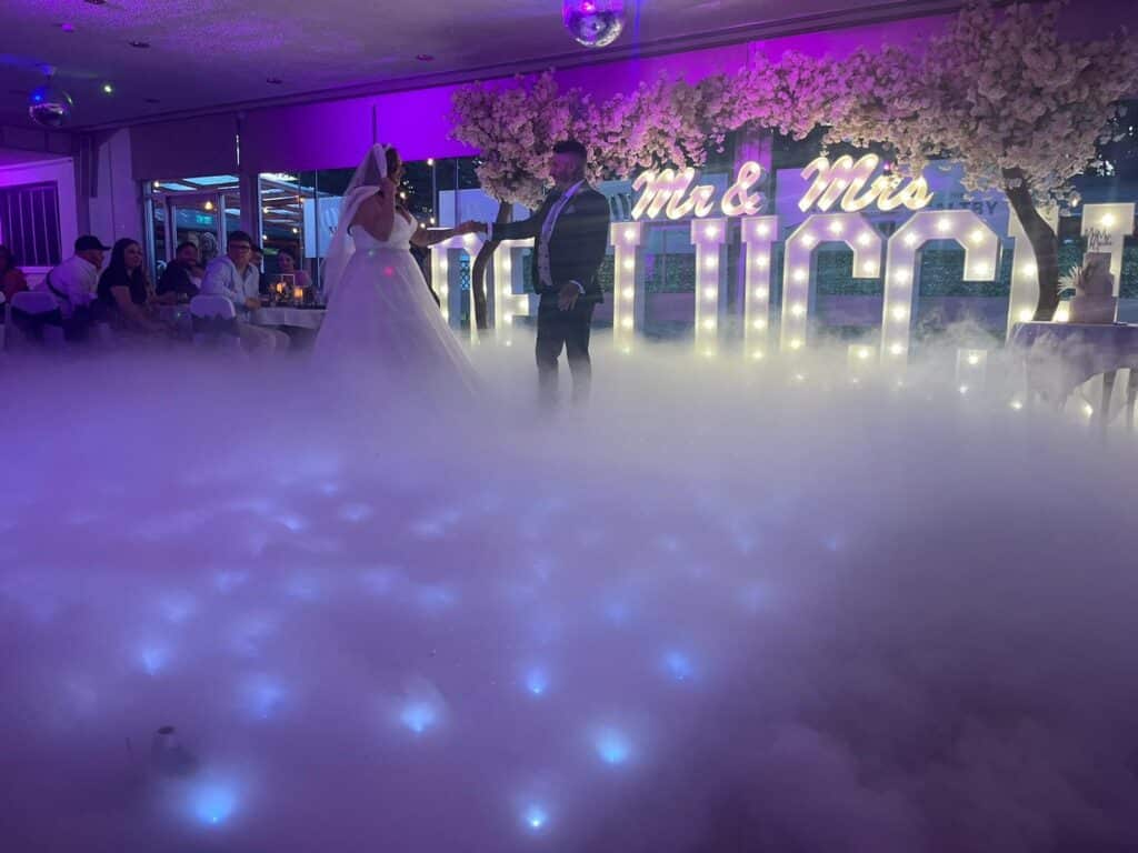 Newlyweds dancing on a starlit dance floor hired from Magnum Entertainment